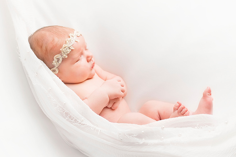 Plano newborn photographer light and airy photos in a white studio