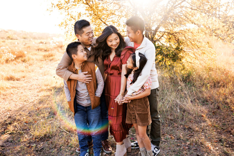 photographer mckinney taking gorgeous family photos in a field in plano