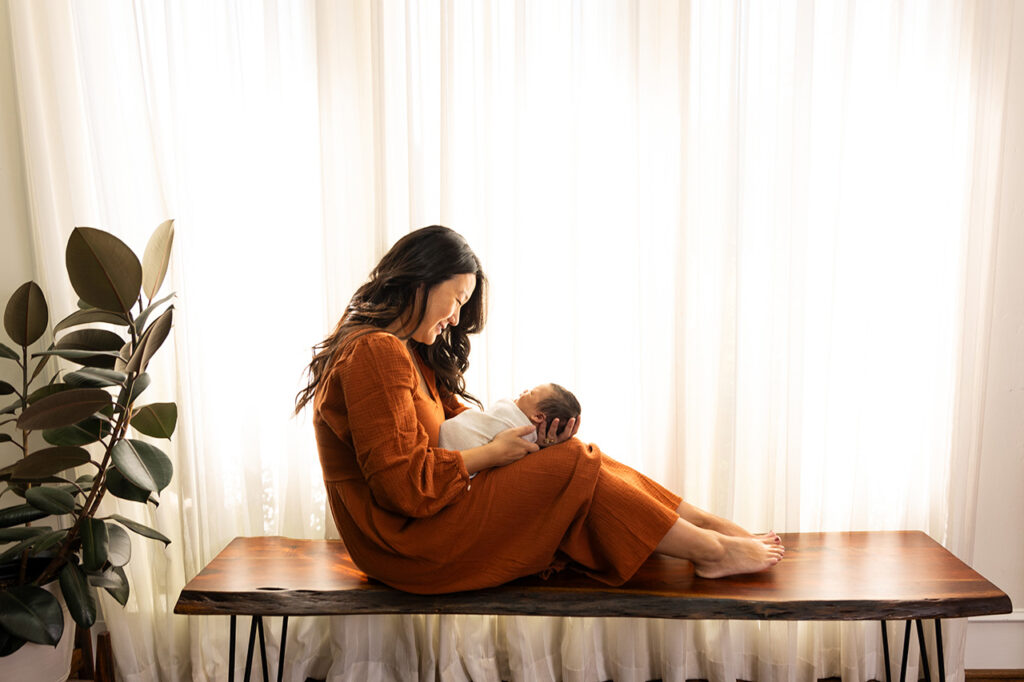 best newborn photographer frisco taking light and airy portraits of mom