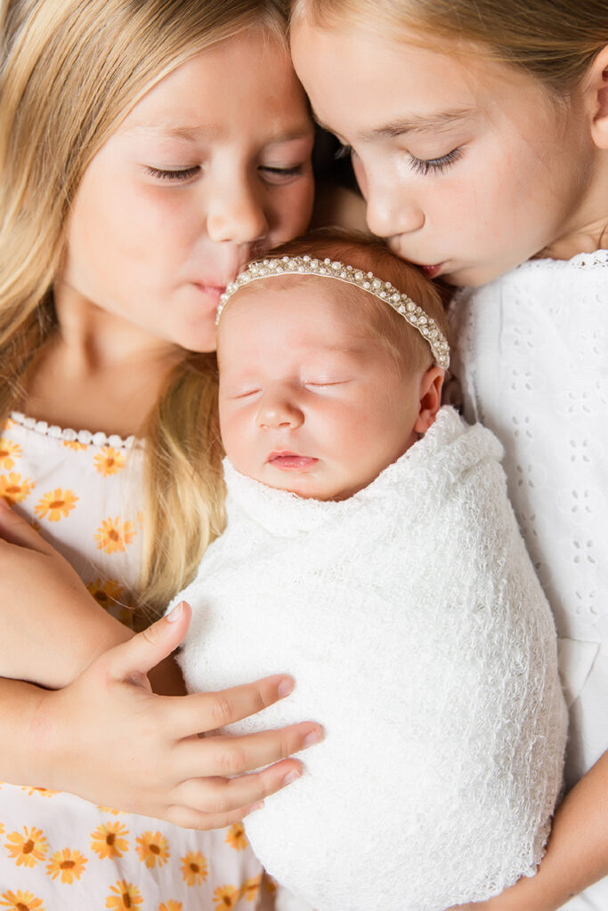 in home newborn frisco photography session with sisters and baby