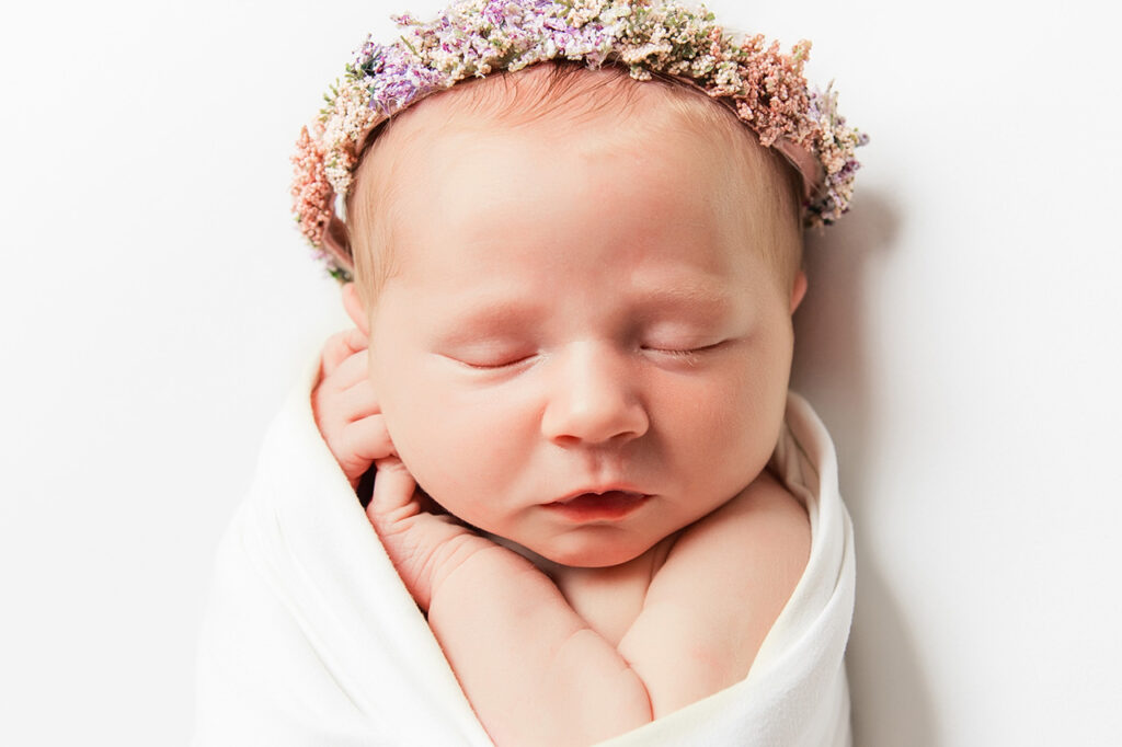 light and airy newborn plano photo session on an all white background