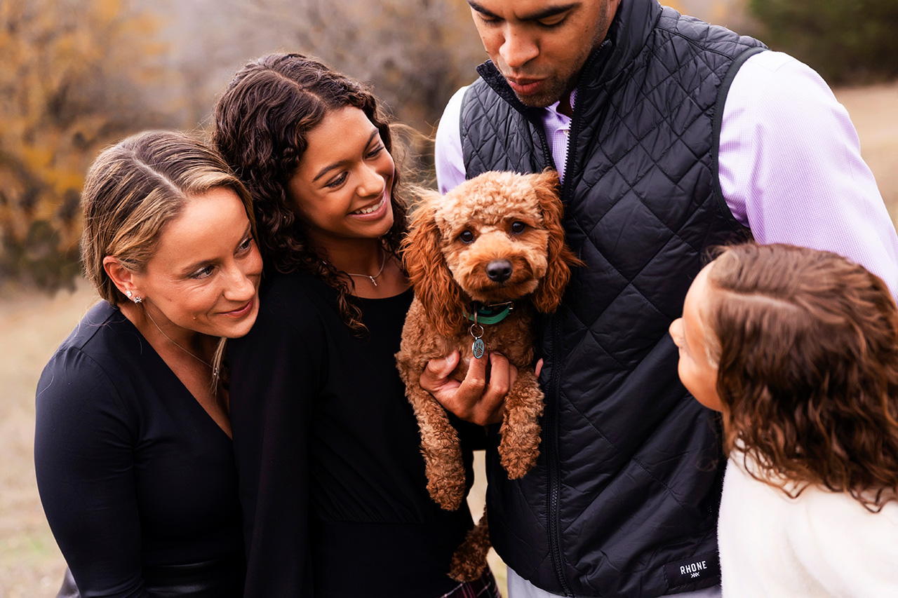 best dfw photographer near me taking family photos with your pet at a field in Plano
