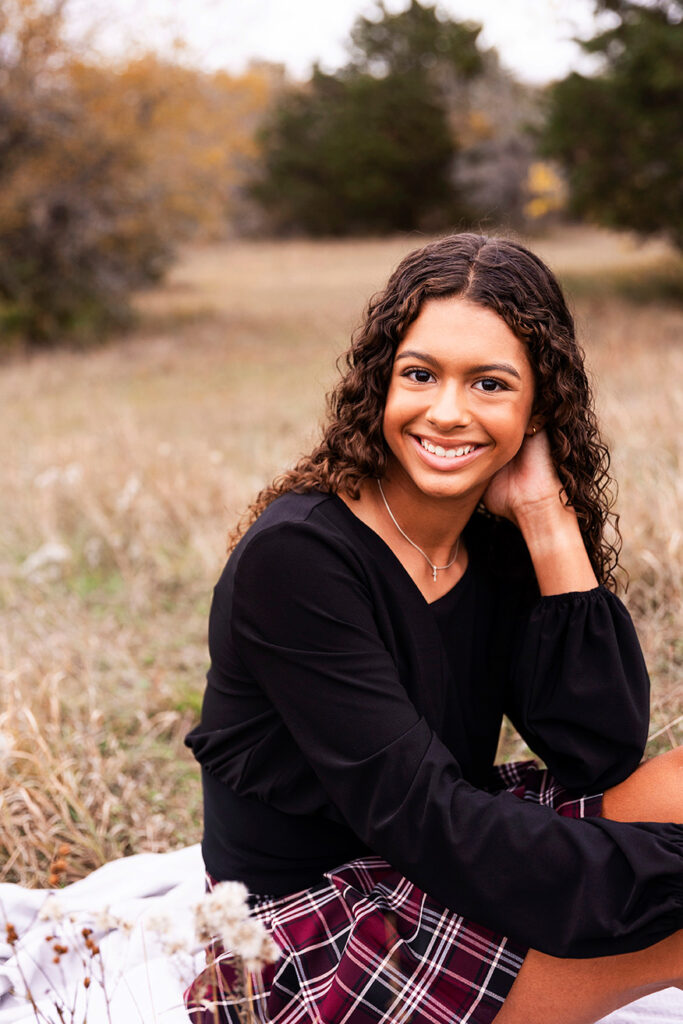 dfw family photographer taking gorgeous photos of your kids at a field in Plano
