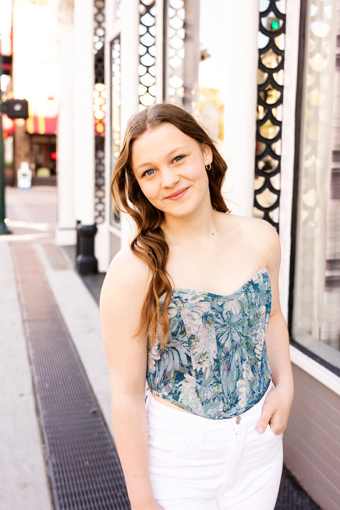 senior girl posing by road in frisco