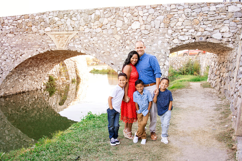 Family posing by two arches