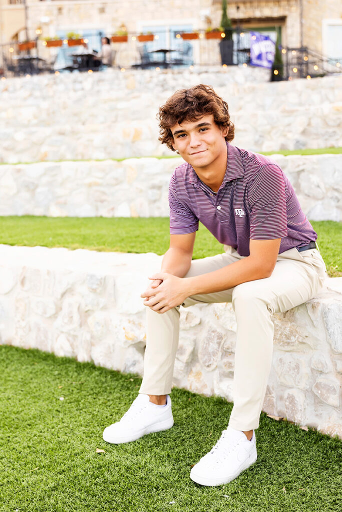 outdoor senior pictures dallas of a guy smiling on steps
