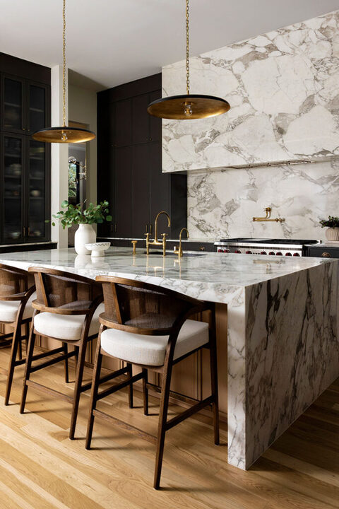 full marble kitchen with gold accents and luxury range in the interior design photoshoot