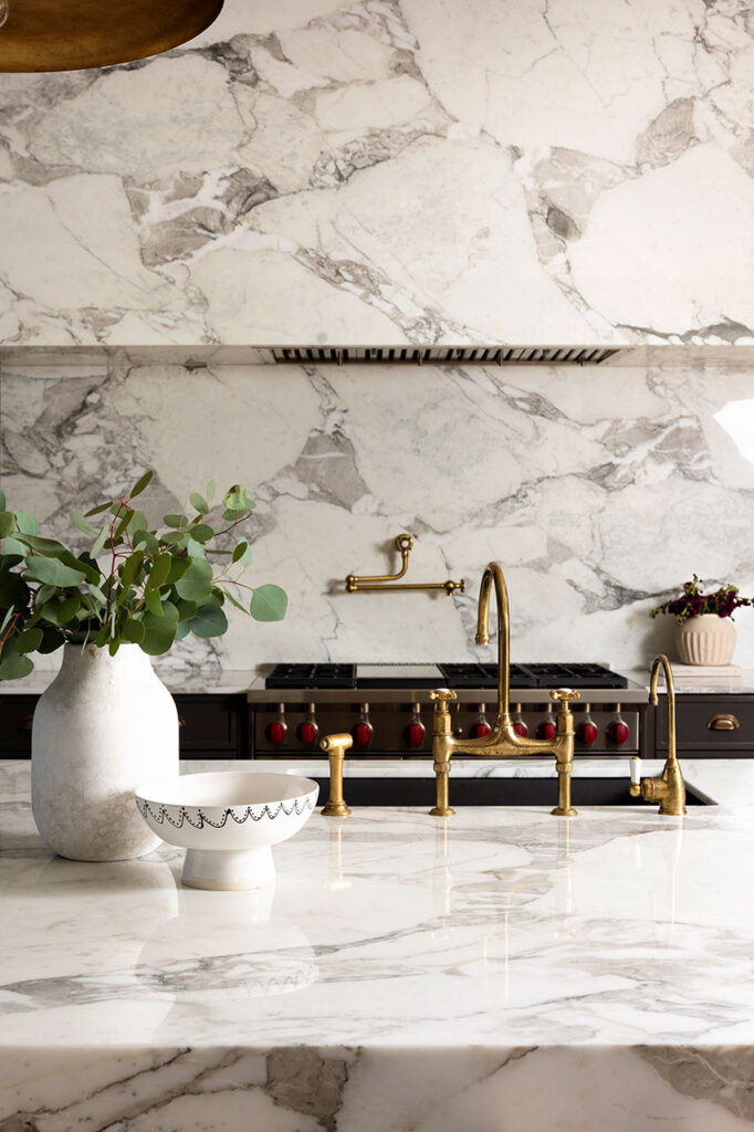 full marble kitchen with gold accents and luxury range interior design photoshoot