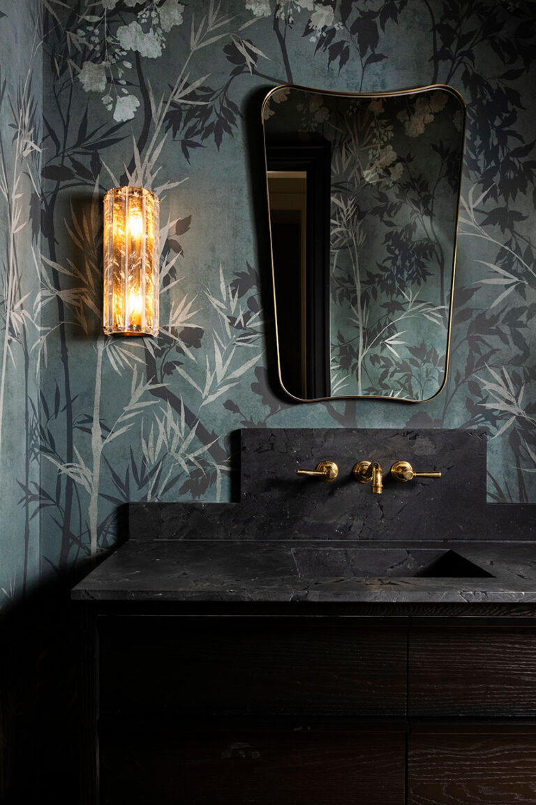 Close-up of dark stone sink and unique finishes in a moody Dallas guest bathroom design