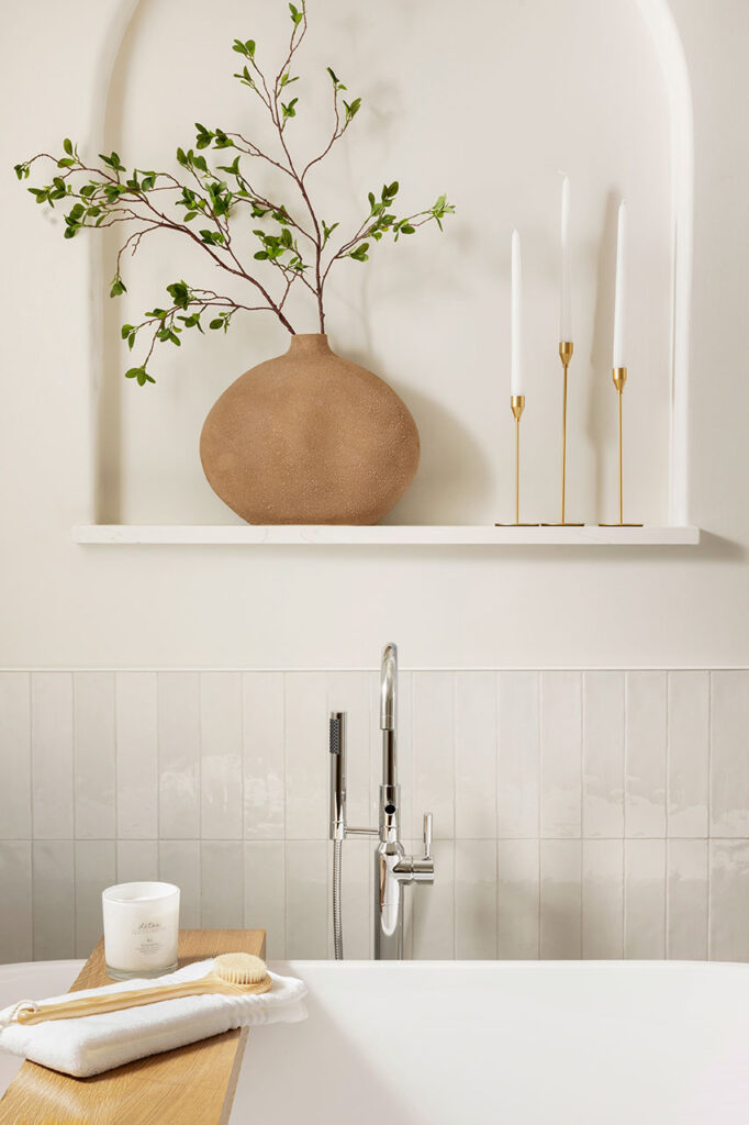 detail shot of a bath tub with chrome finishes and gold accents