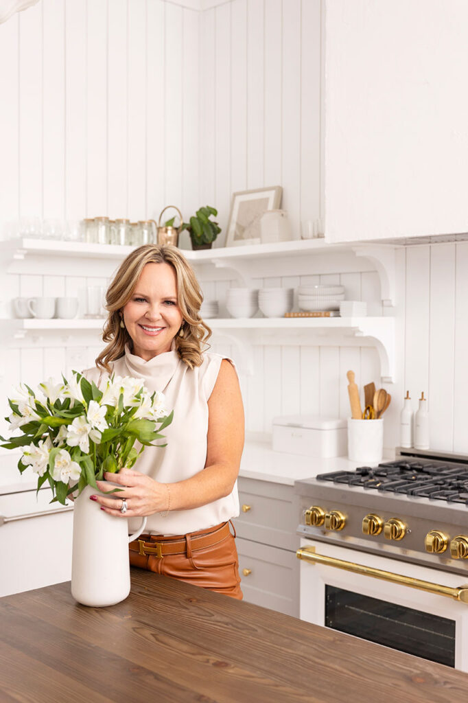 dfw headshot and brand photographer arranging flowers in a kitchen