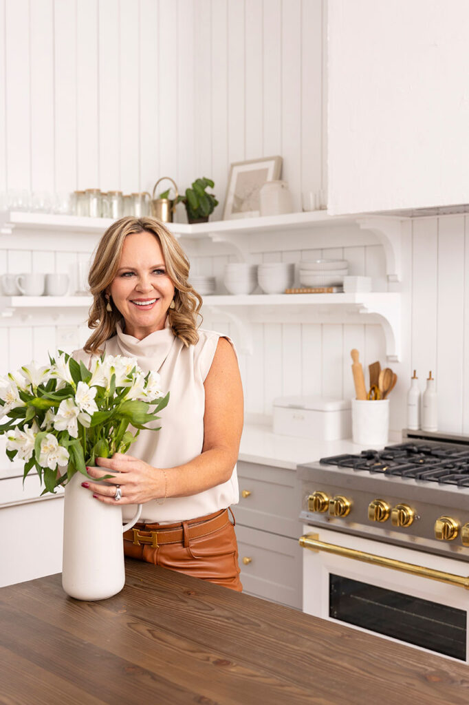 dfw headshot and brand photographer in a kitchen arranging flowers