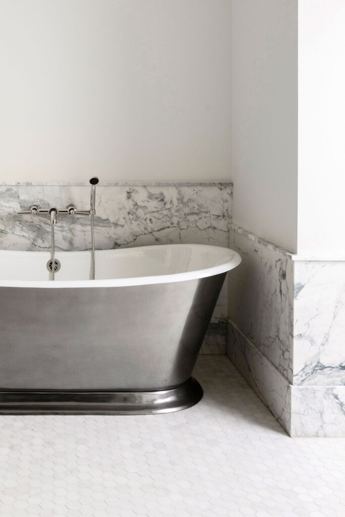 all white bathroom with chrome tub