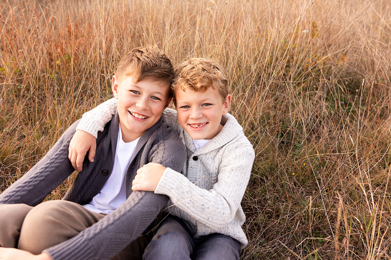 family photos in dallas of two sons at a field in plano
