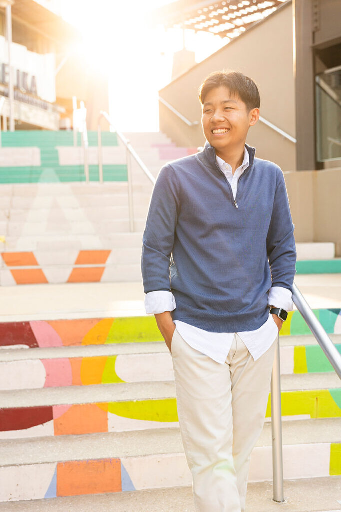senior boy on stairs backlit in dallas