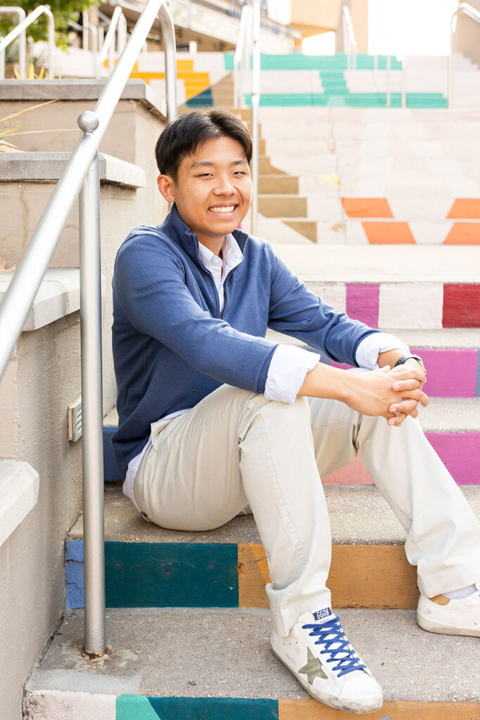 senior photographer headshot of a guy on stairs in dallas