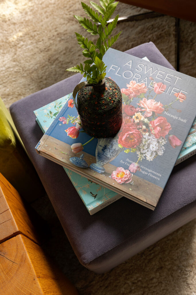 detail shot of a book stack with a plant