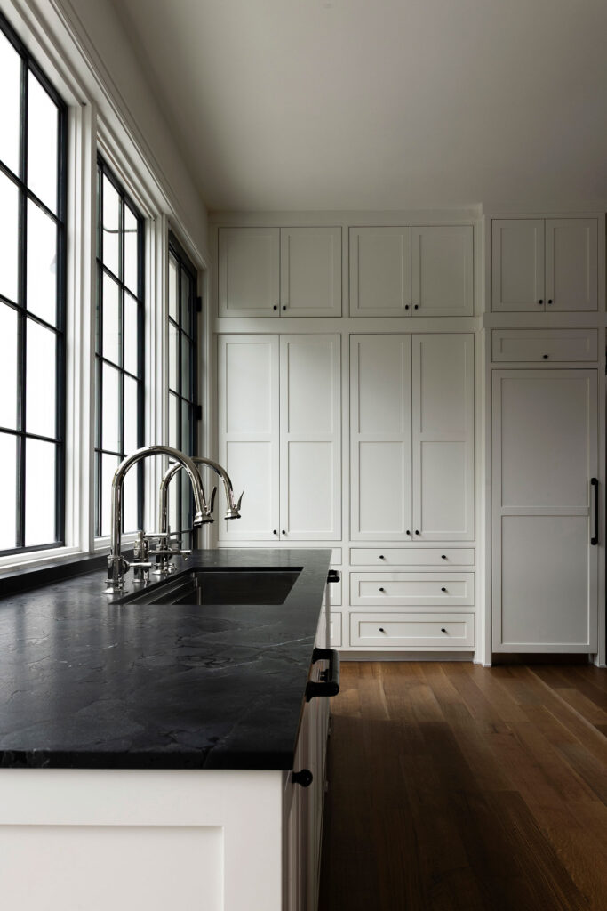 light flowing into black and white kitchen