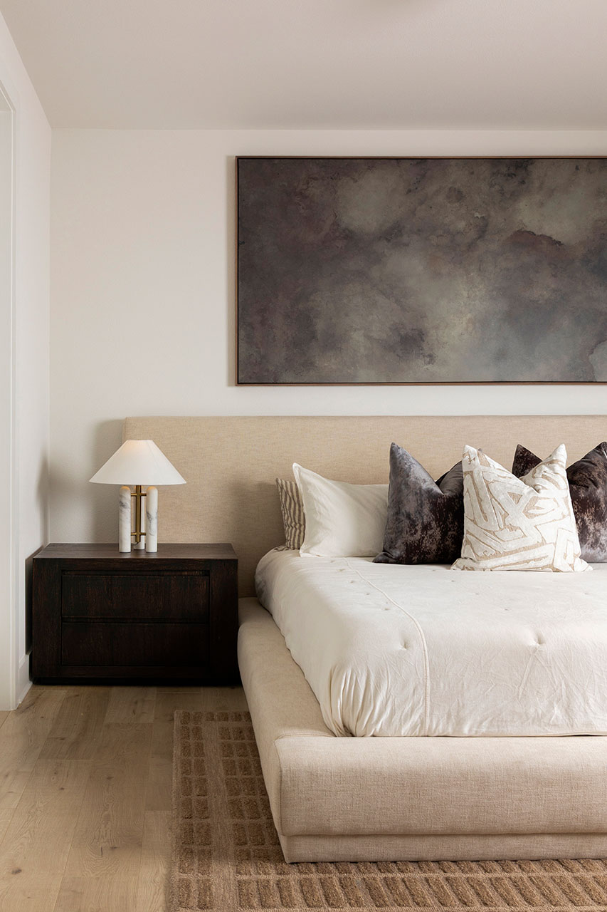 plano interior designer primary bedroom with lamp and bedding