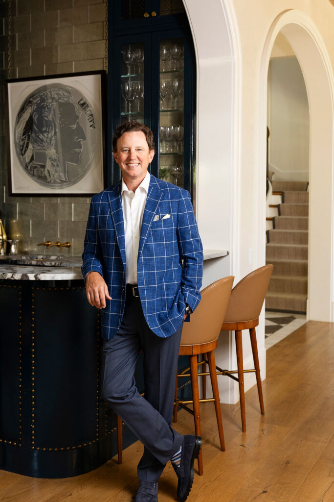 dallas ceo standing in a custom home
