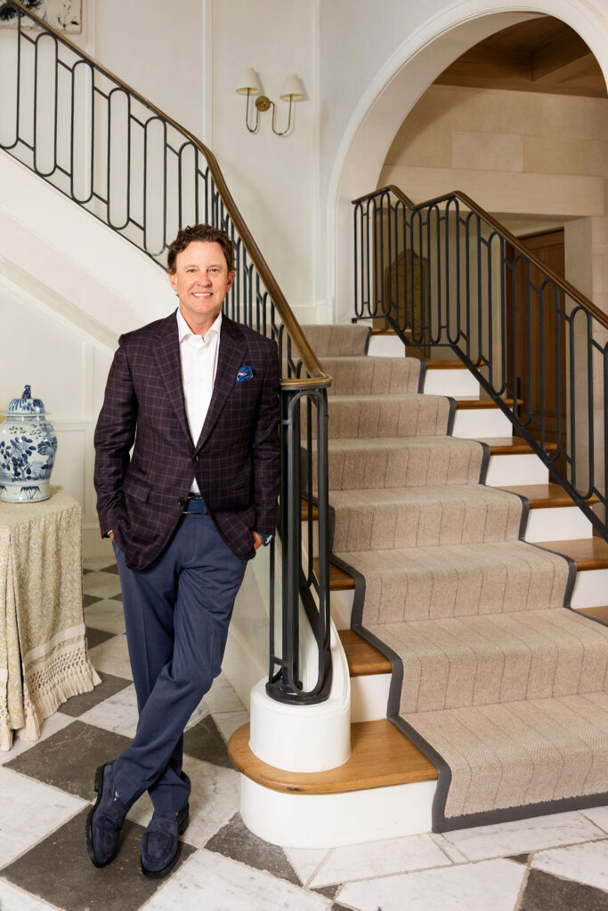 ceo standing next to a staircase